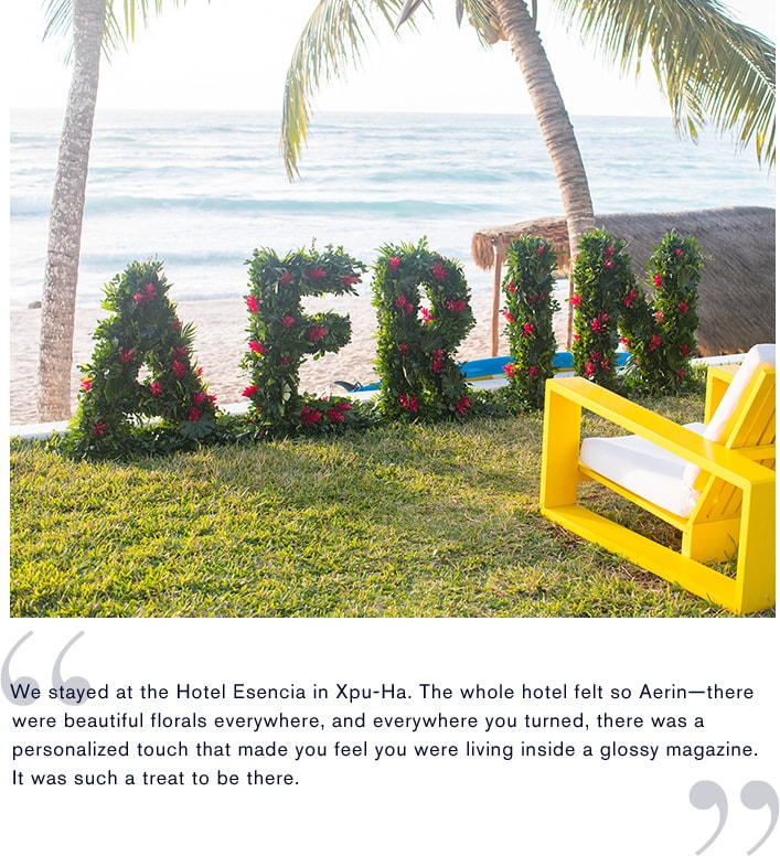 A waterfront floral arrangement spells out AERIN